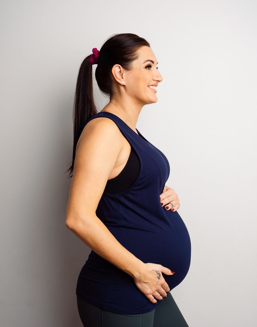 pregnant mother wears a navy nursing tank top