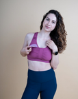 front view of a pink breastfeeding sports bra with dropdown cup unclipped