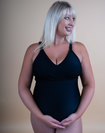 Pregnant mother wearing a black one piece nursing swimsuit
