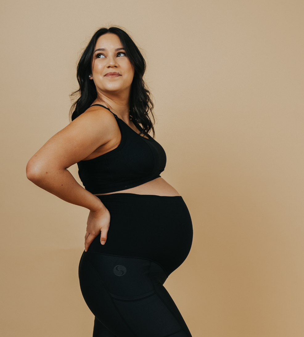 pregnant woman wearing a black racerback nursing bra back view