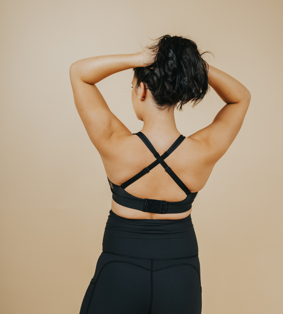 Back view of active mom wearing black nursing sports bra