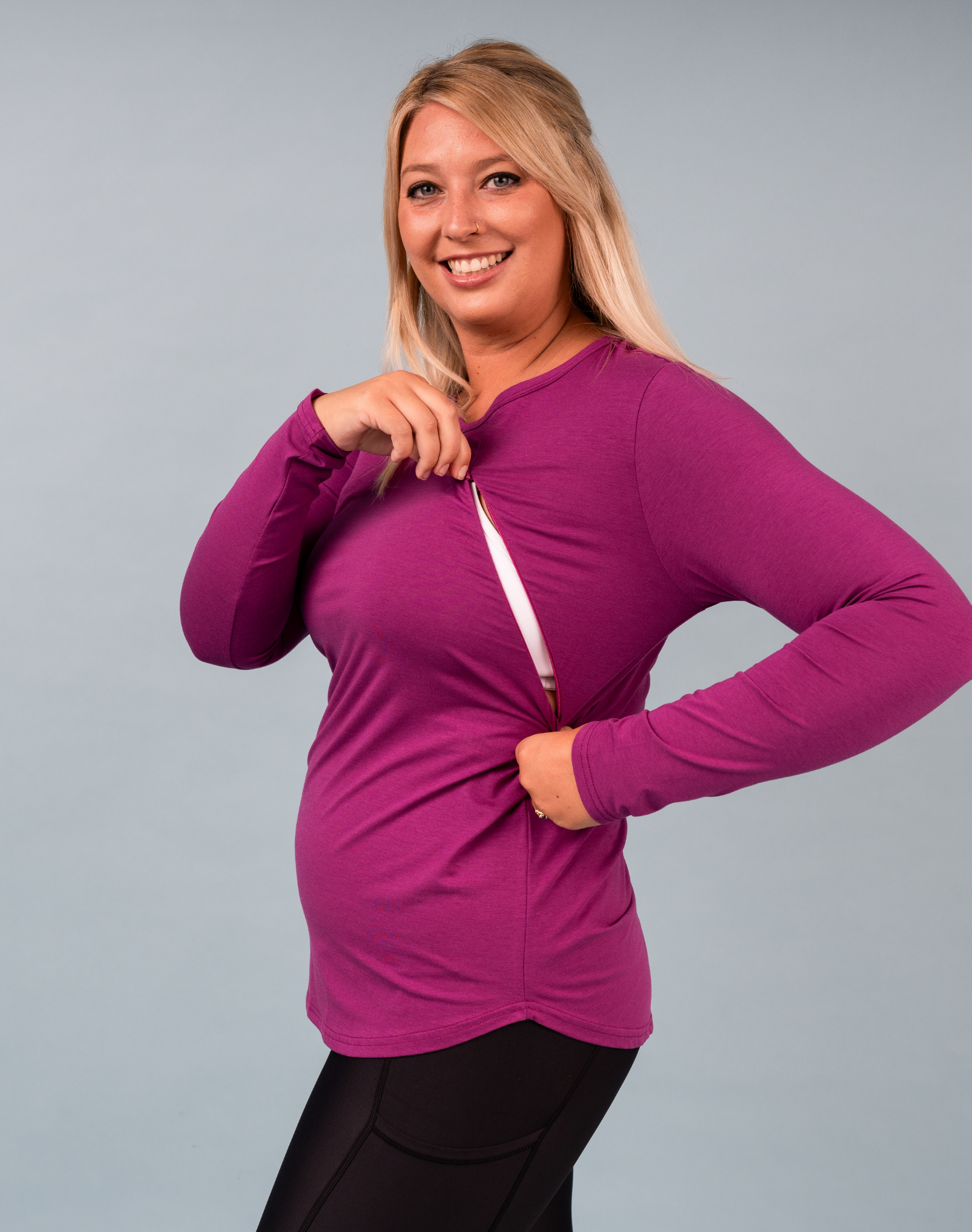 Active mum wearing a magenta nursing long sleeve top