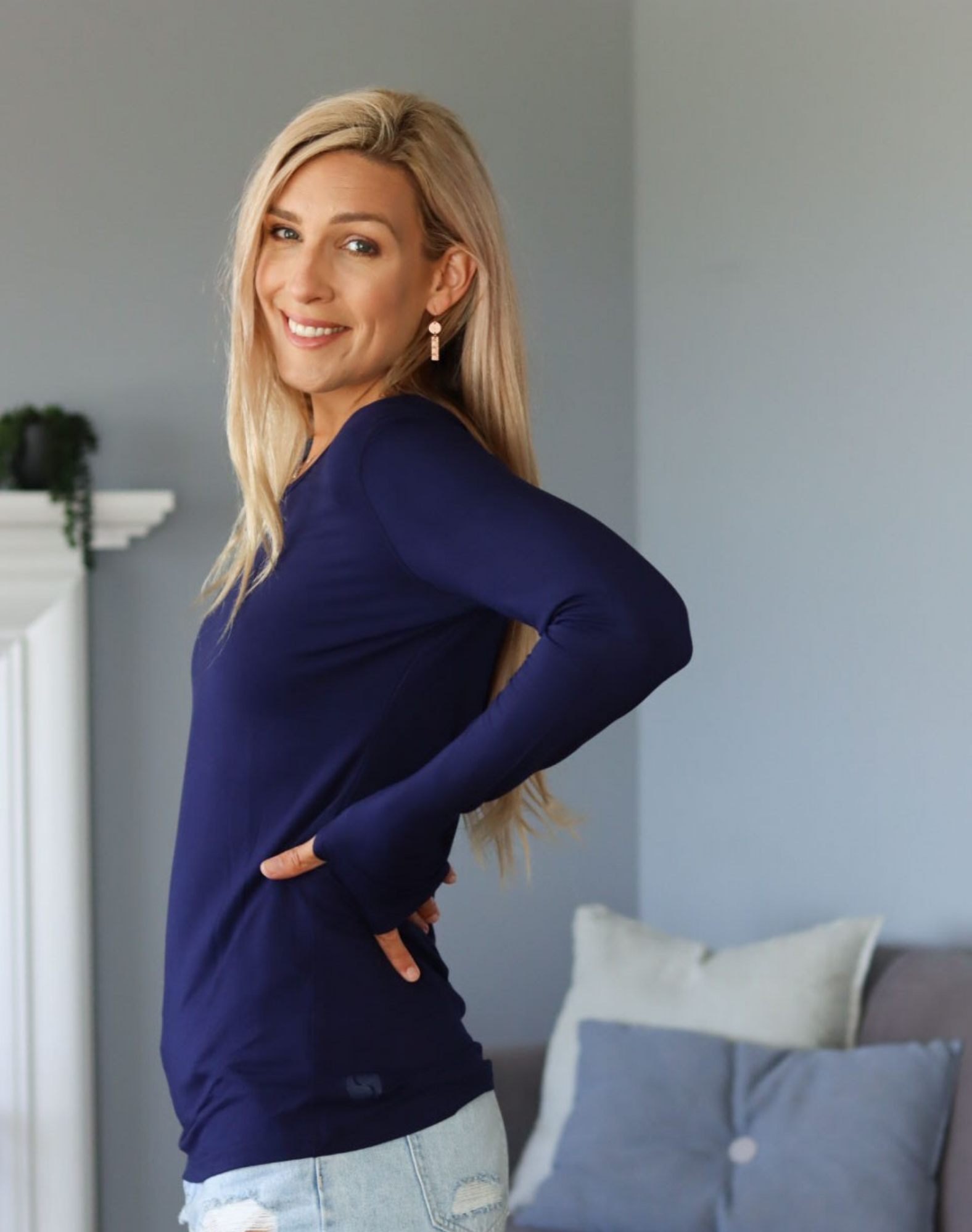 Side view of mum wearing blue activewear long sleeve top