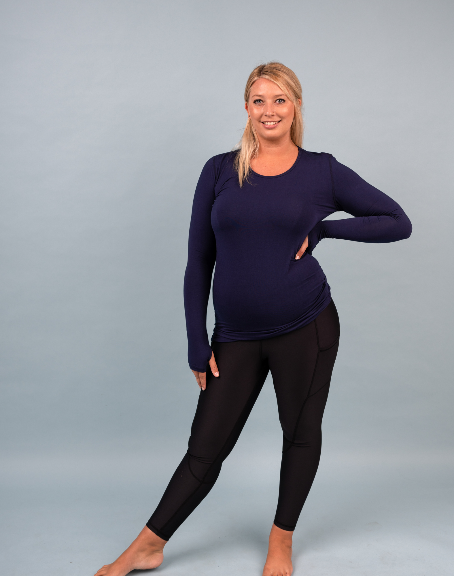 Side view of active mum wearing blue activewear top