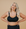 Front view of breastfeeding mom wearing black nursing sports bra