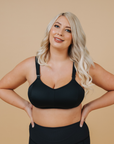 Front view of breastfeeding mom wearing black nursing sports bra