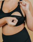 Side view of breastfeeding mom wearing high impact nursing sports bra