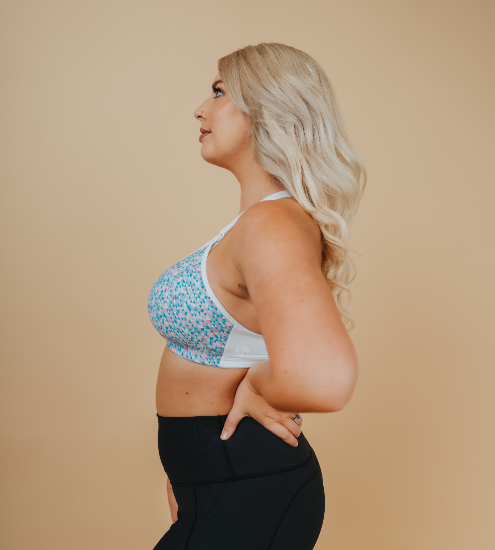 side on view of a happy mom wearing a confetti nursing sports bra