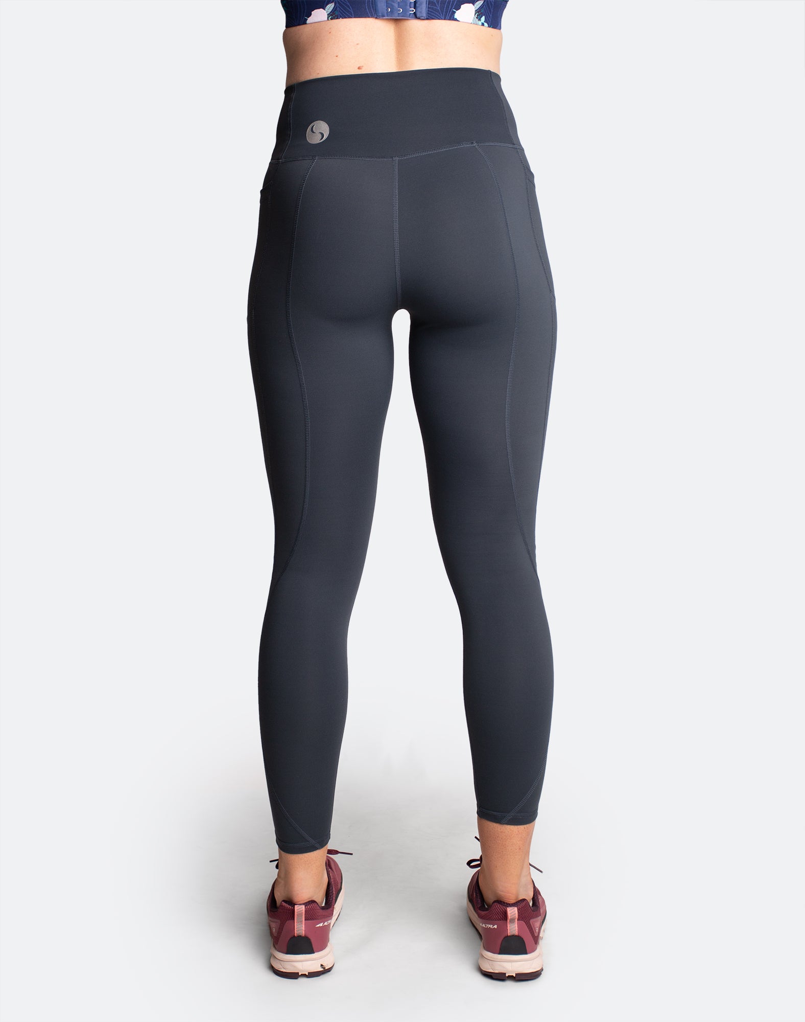 Side view of dark blue high waisted maternity tights with pockets