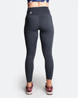 Side view of dark blue high waisted maternity tights with pockets