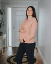 Happy pregnant lady wearing pink nursing hoodie