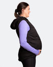 Pregnant mother wearing a black womens puffer vest