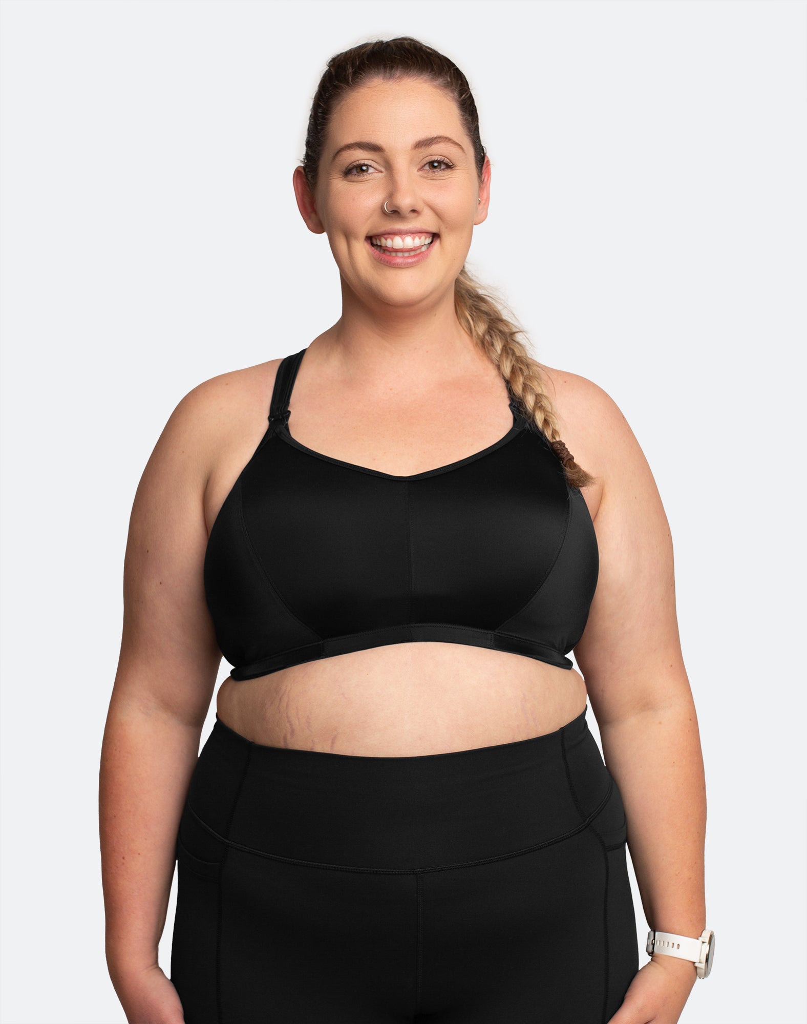 Front view of breastfeeding mom wearing black nursing sports bra