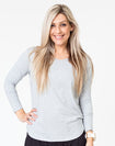 active mum wearing a grey maternity top with long sleeves and invisible zips for breastfeeding