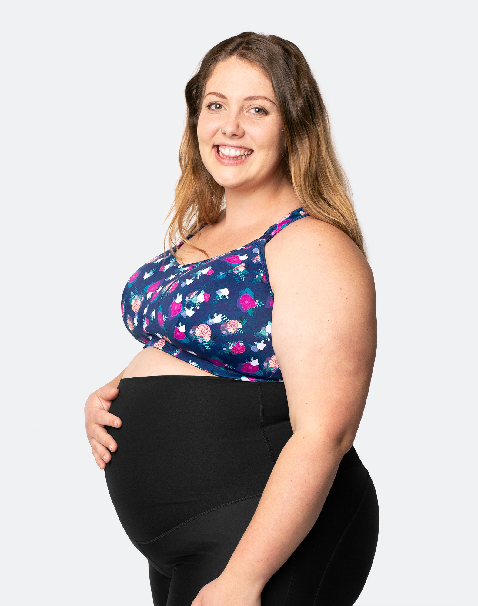 Pregnant mother with baby bump wearing maternity activewear