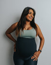 Expecting mother wearing green breastfeeding bra