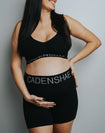 Expecting mother holding pregnant belly wearing matching co-ordinate bamboo underwear